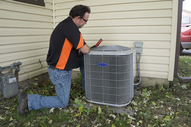 5 Common AC Problems. Tech at AC Unit.