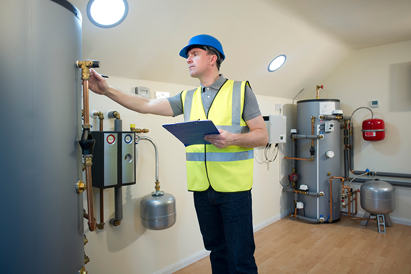 How Can I Make My Furnace Last Longer? Man checking unit.