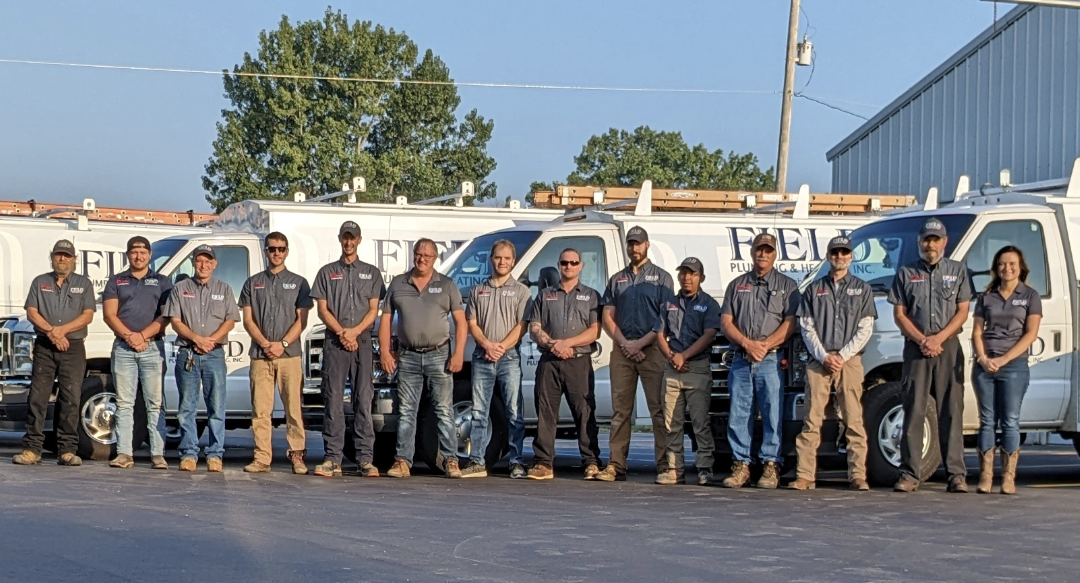 field team standing in front of trucks.